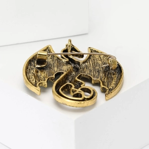 Detail view of the bronze vintage dragon brooch back with a secure rotating pin clasp