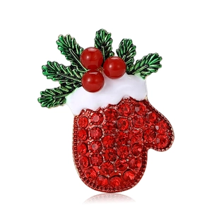 Christmas mitten brooch with red rhinestones, green holly leaves, and gold metal finish