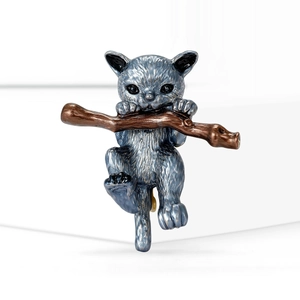 Cute gray-blue cat alloy brooch hanging on a brown branch with textured metallic finish