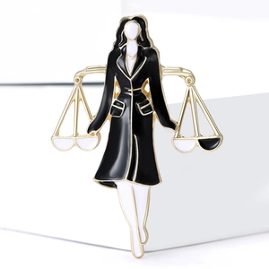 Lawyer themed brooch of professional lady holding scales of justice in black enamel
