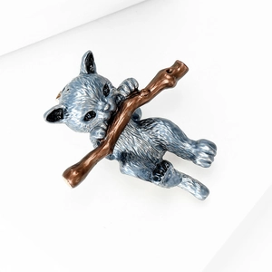Detail of an alloy enamel brooch featuring a cute blue cat climbing a brown branch