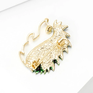 Creative hedgehog brooch back view in gold alloy with green enamel and safety pin