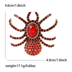 Vintage gold spider brooch with large red rhinestone and faceted crystals for suits