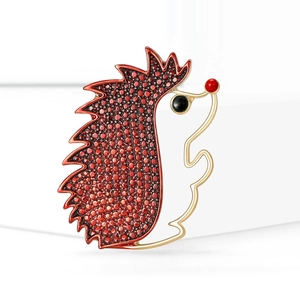 Creative hedgehog brooch in gold alloy with red textured enamel for versatile styling