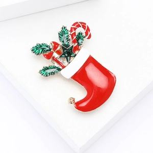 Christmas stocking brooch in red enamel with inlaid diamonds and holly leaf accents