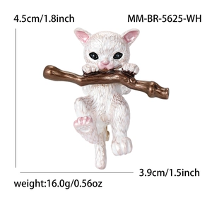 Cute white cat enamel brooch pin with bronze branch detail on a clean white background