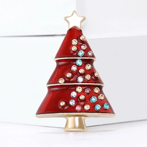 Enamel Christmas tree brooch with colorful rhinestones and gold star on white pedestal