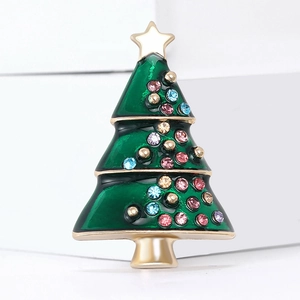 Green enamel Christmas tree brooch with colorful rhinestones in a minimalist studio setting