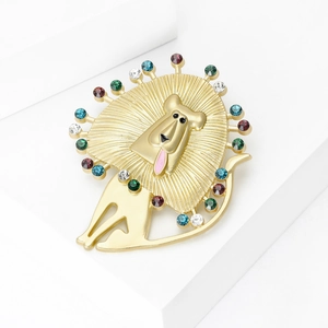 Matte gold lion brooch with colorful rhinestones on a white geometric background