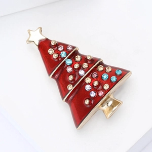 Detail of red enamel Christmas tree brooch with colorful rhinestones and gold plating