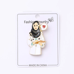 Detail of doctor brooch with hijab and stethoscope on white fashion jewelry card