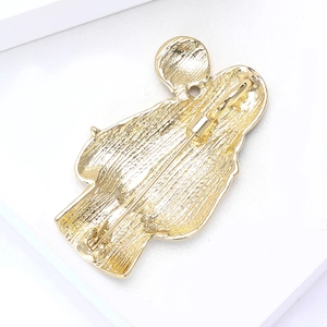 Detailed back view of a doctor silhouette brooch featuring golden alloy and safety pin