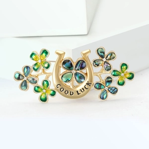 Exquisite gold clover horseshoe brooch with green enamel and sparkling rhinestones
