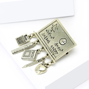 Vintage bronze math teacher brooch with blackboard, calculator, and pencil charms