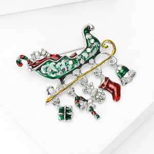 Detail of Christmas sleigh brooch with oil-dripped pendants and sparkling rhinestones