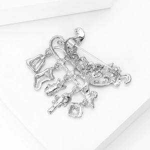 Detailed back view of Christmas alloy brooch featuring bell and stocking charms