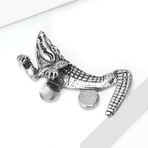 Detailed close-up showing the antique silver texture and scales of crocodile brooch