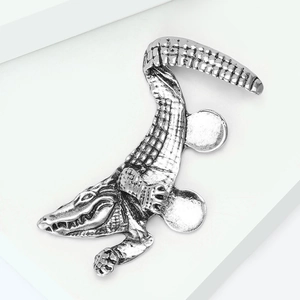 Detail of vintage silver crocodile ear cuff showing intricate bionic scale texture