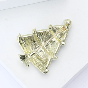 Detailed back view of golden Christmas tree brooch showing textured metal and secure pin