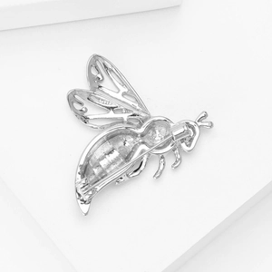 Detailed back view of a silver bee brooch showing the horizontal safety pin and clasp