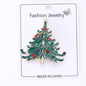 Detailed view of Christmas tree brooch with green enamel and sparkling rhinestones