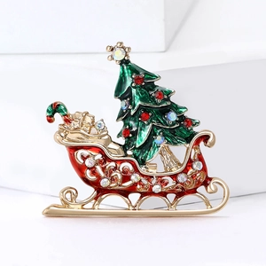 Festive Christmas sleigh brooch with multicolored rhinestones on a white geometric background