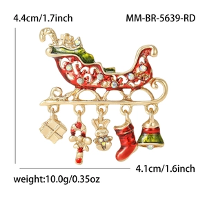 Christmas sleigh brooch with festive enamel charms including bears and bells on white background