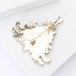 Detailed back view of golden alloy Christmas tree brooch showing the safety pin fastener