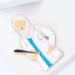 Cartoon enamel doctor brooch featuring a hijab-wearing female medic with a stethoscope