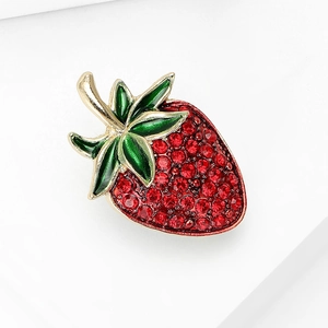 Elegant strawberry brooch with red rhinestones and green enamel on a golden metal base