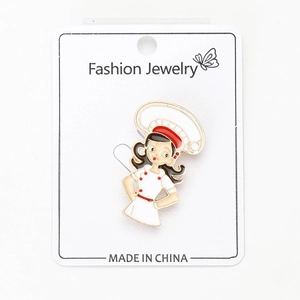 Detail view of cartoon chef girl enamel pin on jewelry display card for lapel or suit