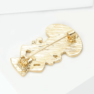 Close-up of the golden metal alloy brooch back with pin clasp and safety lock