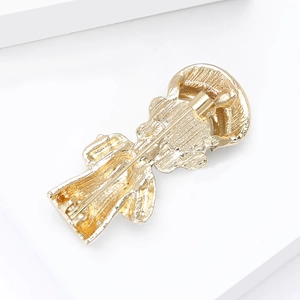 Detailed back view of golden chef brooch featuring a secure rotating safety pin clasp