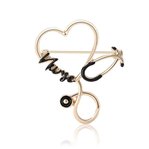 Golden nurse stethoscope brooch with heart design and black enamel lettering on white background