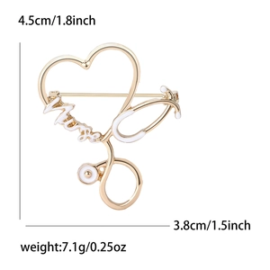 Golden stethoscope heart brooch with white enamel Nurse lettering on white background