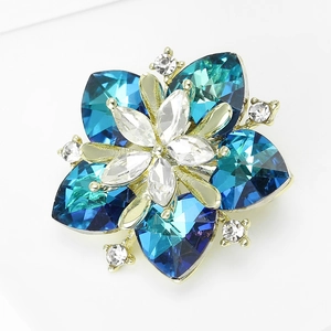 Close-up of luxury sunflower brooch with blue heart-shaped crystals on gold alloy base