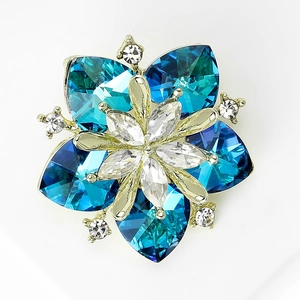 Detailed view of sunflower brooch with blue heart-shaped crystals and gold metal base