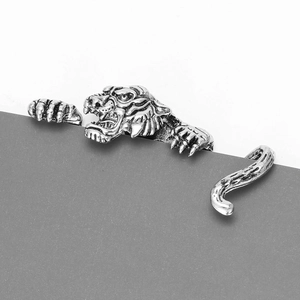 Detailed view of an antique silver vintage tiger ring with intricate punk texture