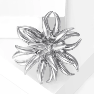 Elegant silver alloy fireworks brooch with layered radial spikes on a white pedestal