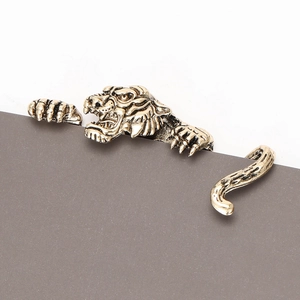 Detailed view of vintage gold tiger brooch with textured fur and majestic roaring expression
