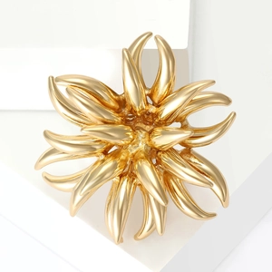 Elegant golden fireworks burst brooch featuring layered petal design for suits