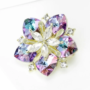 Macro shot of luxury sunflower brooch with heart-cut colorful crystals and gold base