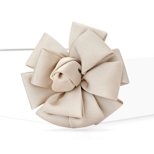 Close-up of champagne satin fabric flower brooch with multi-layer petal texture