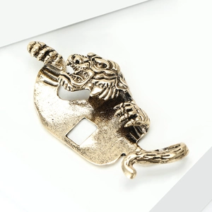 Macro detail of vintage alloy tiger brooch with antique gold finish and textured metal surface