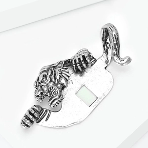 Macro detail of vintage silver tiger head brooch with antique finish and cutout design
