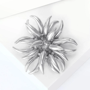 Detailed view of silver fireworks starburst brooch on geometric white stand