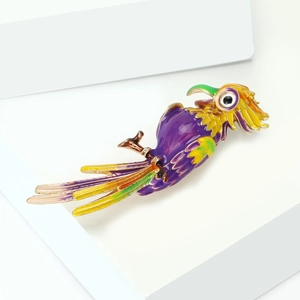 Detail of a colorful parrot brooch with enamel finish perched on a metallic branch