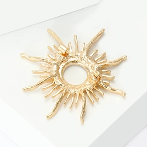 Detailed back view of gold sunburst brooch showing secure pin fastener mechanism