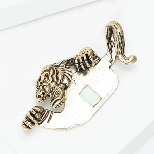 Detail of vintage gold-toned alloy tiger brooch with enamel finish for men suit