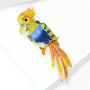 Detail of colorful parrot brooch with enamel gradients and gold-plated finish
